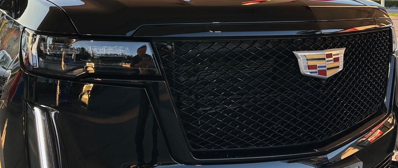 Continental Cadillac Escalade ESV — blacked-out grille and illuminated Cadillac crest