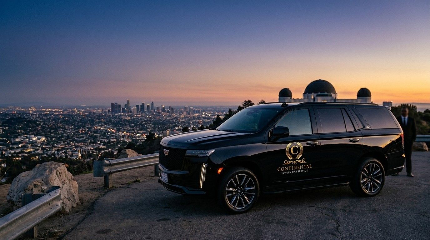 Continental Cadillac Escalade with chauffeur at Griffith Observatory overlooking the Los Angeles skyline at dusk