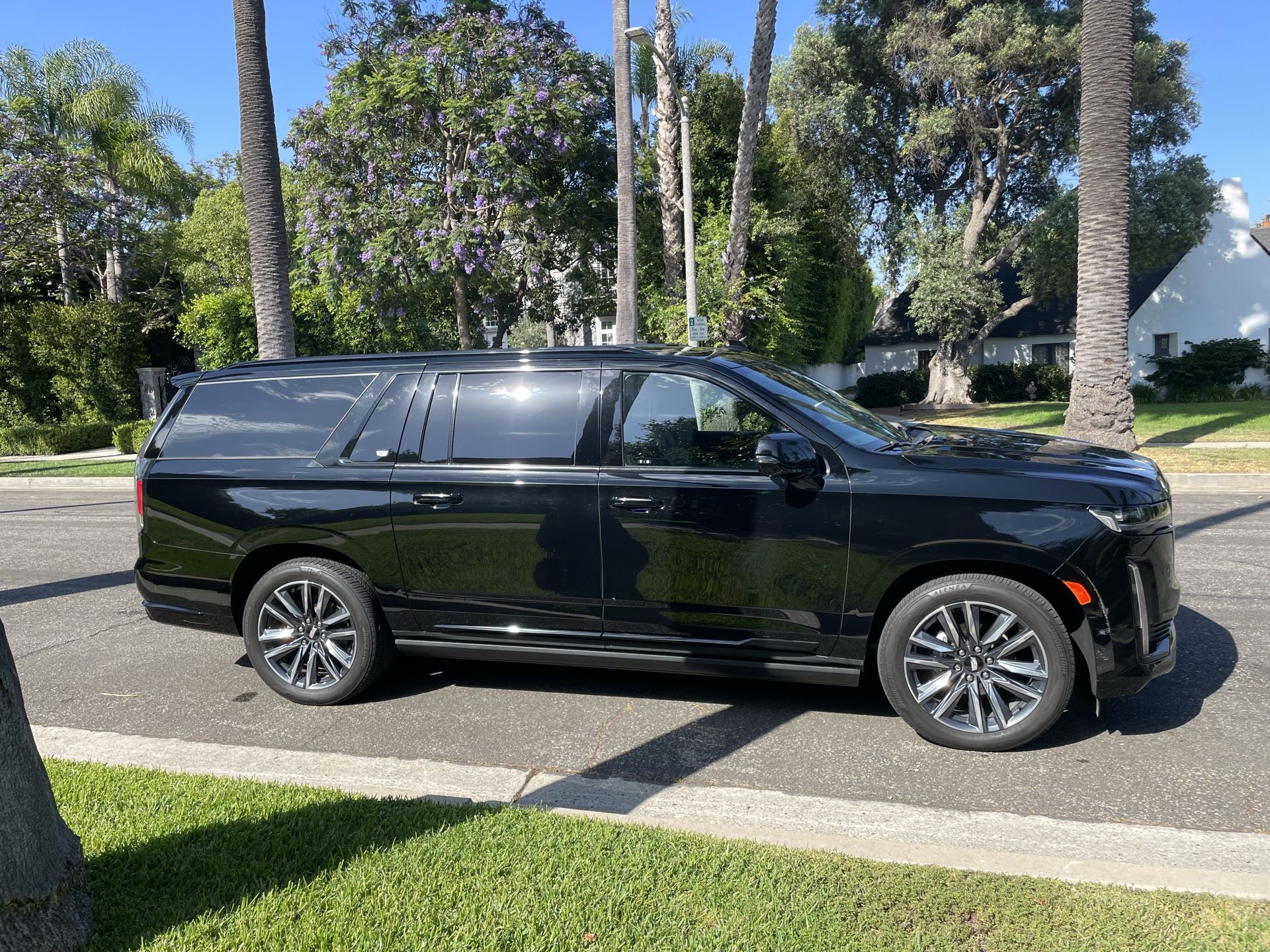 Continental Cadillac Escalade on a palm-lined street at golden hour — Concierge car service, Los Angeles